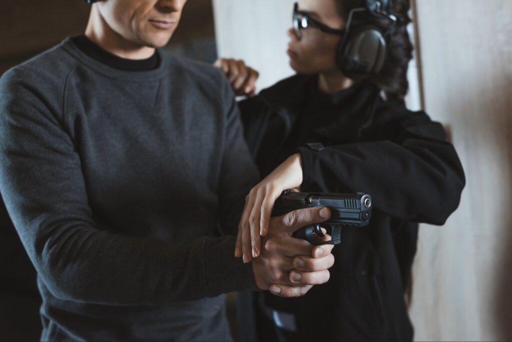 Firearm instructor coaching a student during concealed carry training