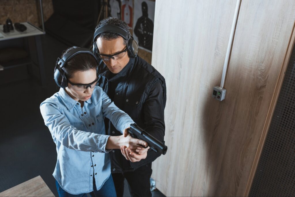Beginner learning proper firearm safety techniques during a training class