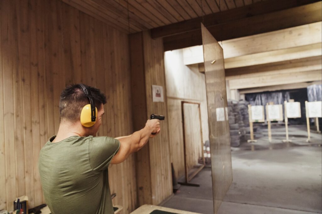 Modern indoor shooting range with shooters practicing handgun accuracy