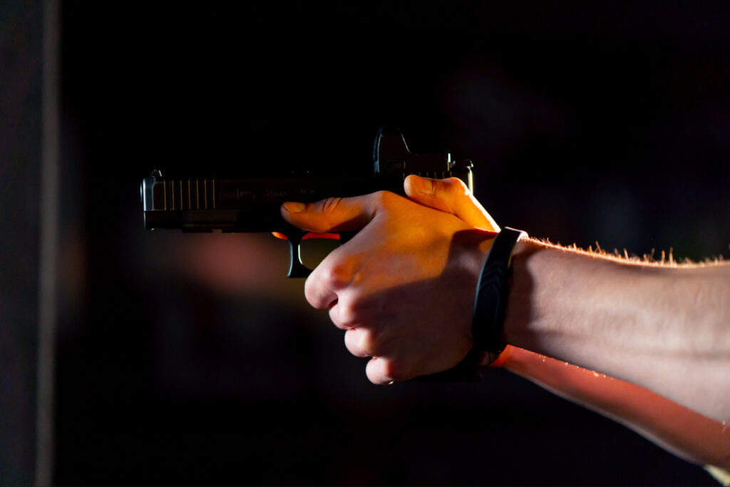 Instructor demonstrating the correct handgun grip to a new shooter