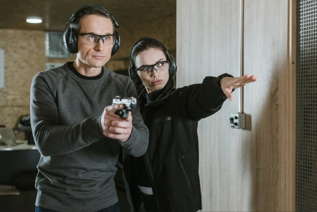 Certified instructor coaching a student on shooting stance and trigger control