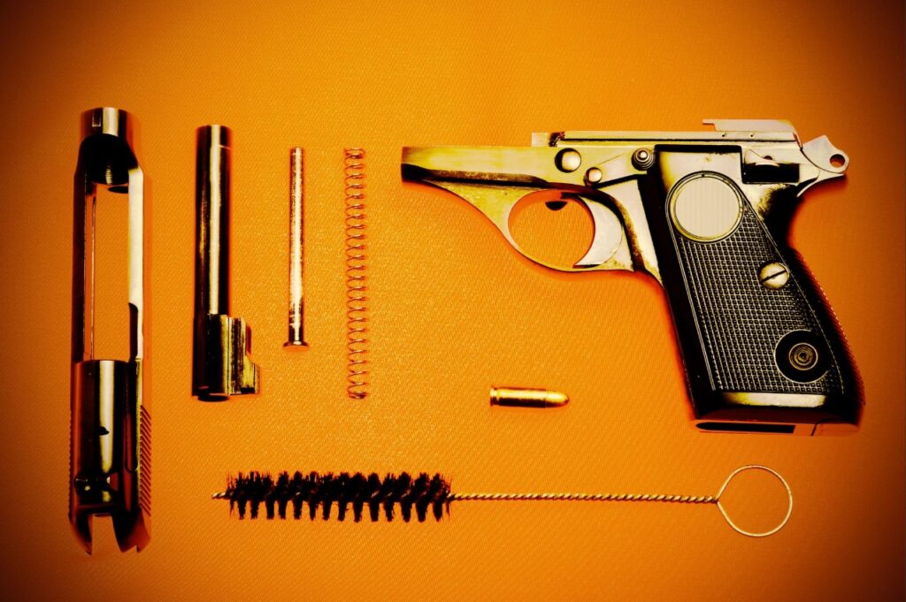 handgun cleaning in Sarasota | Gun owner cleaning the barrel of a semi-automatic handgun using a bore brush