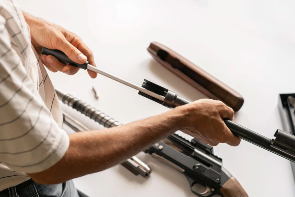 handgun cleaning in Sarasota | Responsible firearm owner inspecting a cleaned handgun before practicing at an indoor shooting range