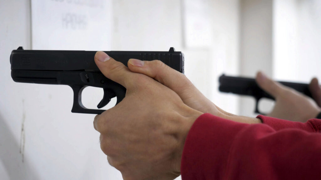 Shooter practicing handgun shooting stance in Sarasota during a target shooting session