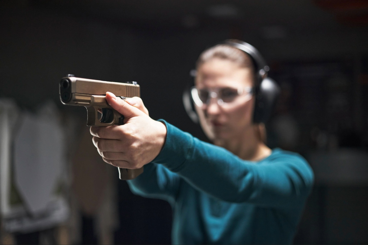 Shooter practicing a handgun shooting stance in Sarasota at an indoor shooting range