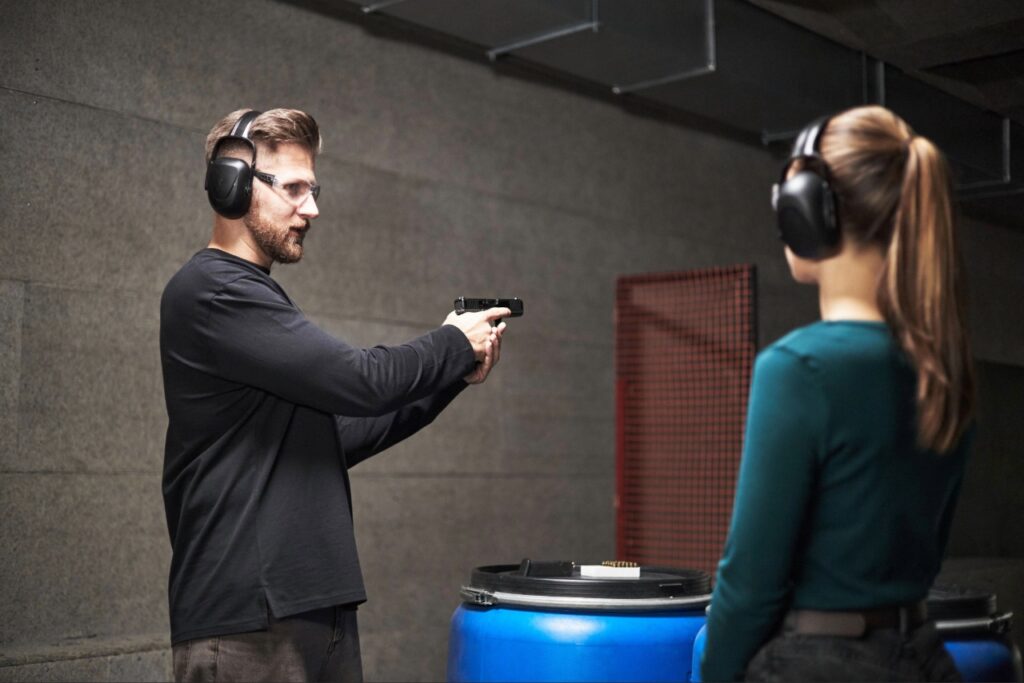 Firearm instructor helping a shooter improve their handgun shooting stance in Sarasota