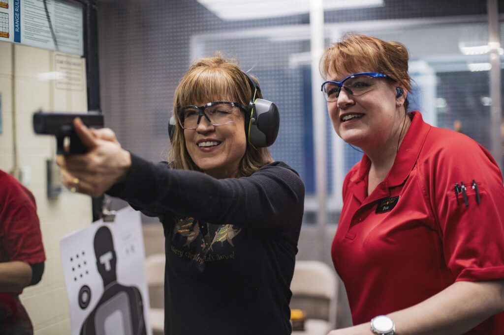 Women-only firearm training Sarasota participant discussing experience and goals with an instructor