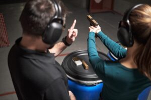 Private firearm lessons Sarasota with instructor and adult student at an indoor shooting range