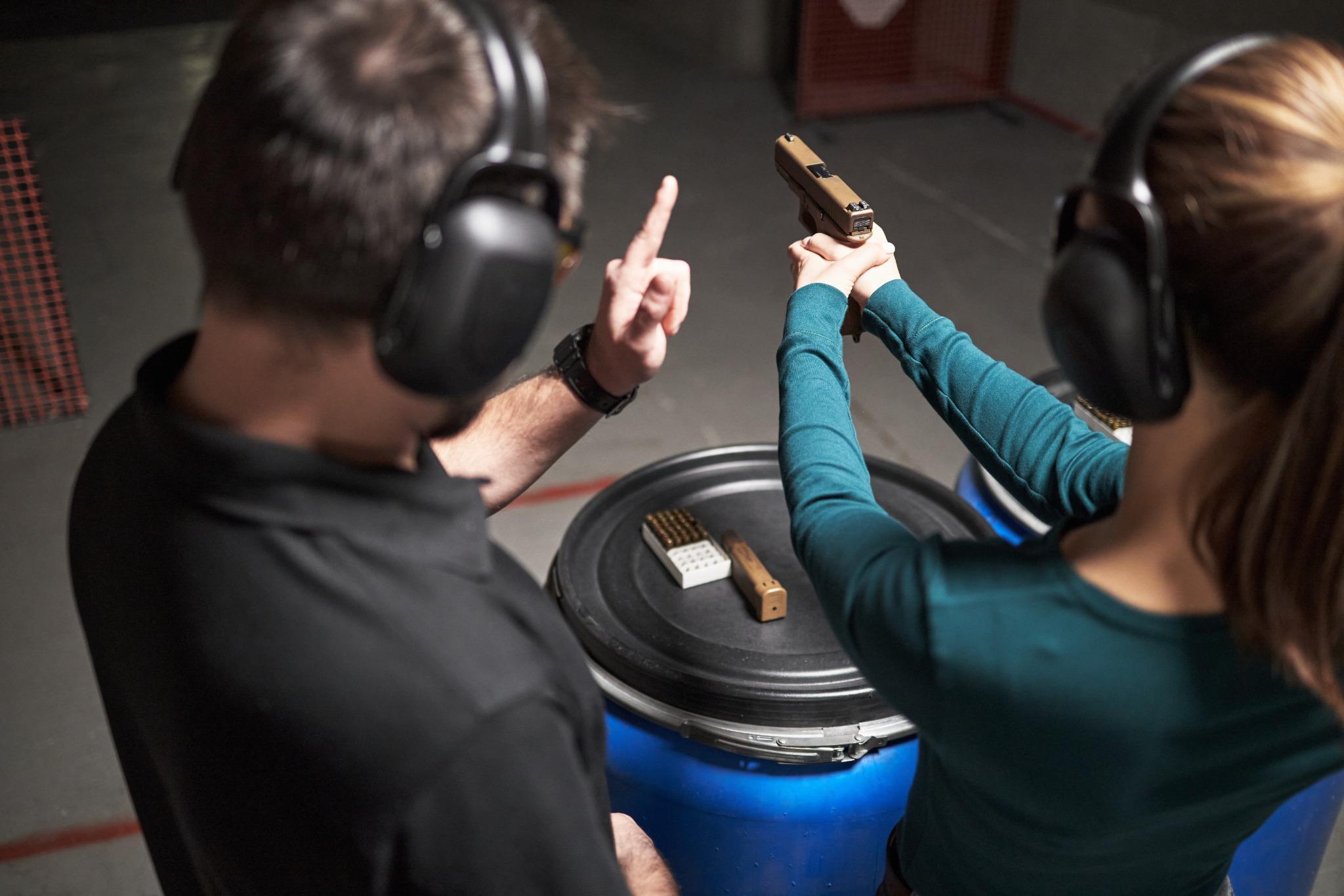 Private firearm lessons Sarasota with instructor and adult student at an indoor shooting range