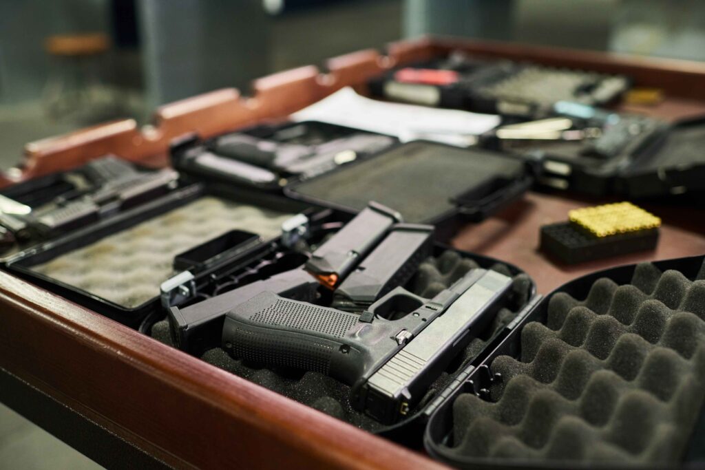 Visitor asking about event registration and arrival requirements at a shooting range counter